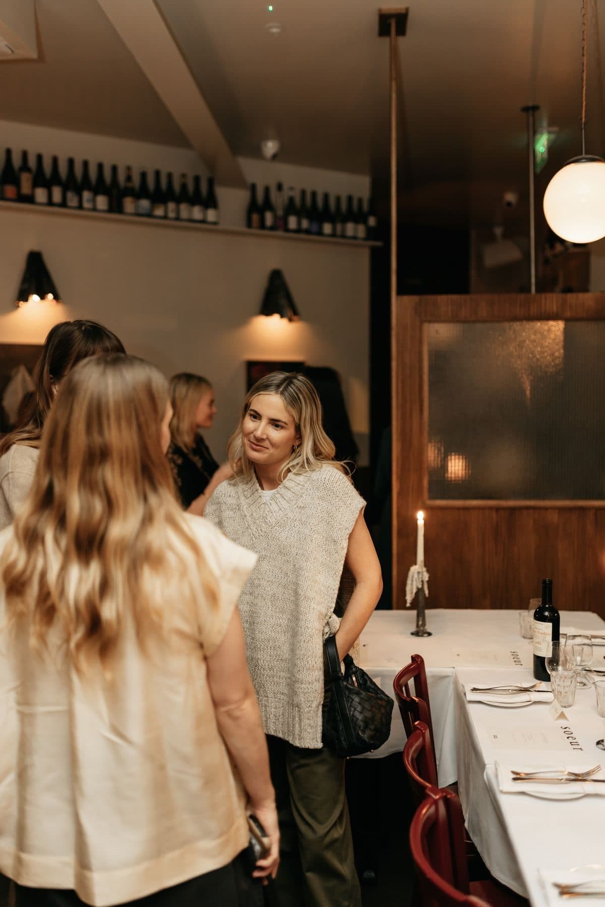 Guests mingling at a candlelit NOR Table brand launch dinner.